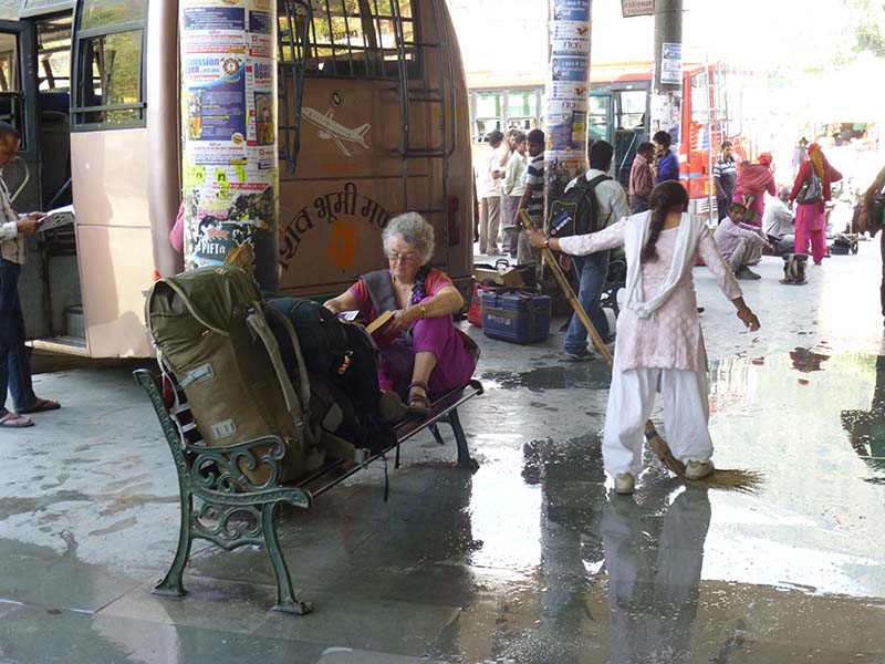 Waiting for the bus in the Kulu Bus stand. Floor washing time - scrub that cow shit!