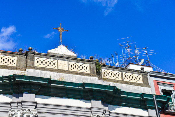 Ancient and modern symbols stand side by side on the rooftops.