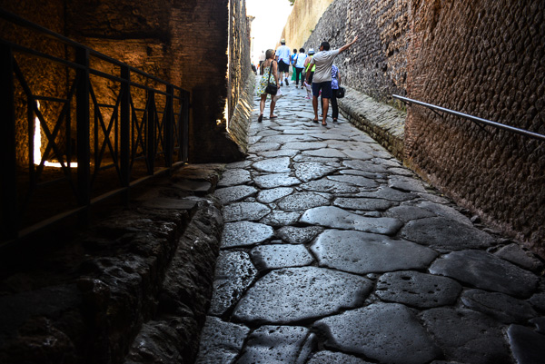 Warn by the centuries, huge flagstones mark the entrance to Pompeii.