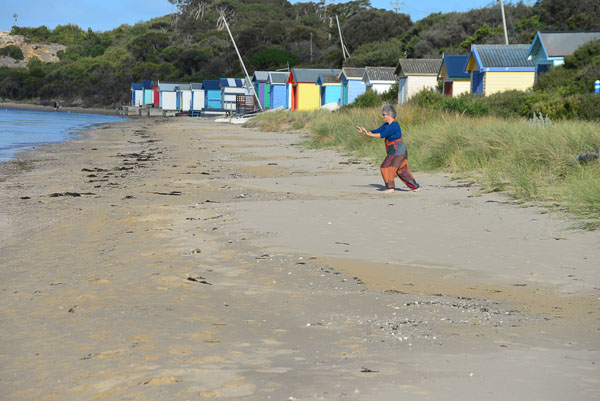Jacqui does her Tai Chi in front of the beach huts at Rye. Fancy one? Got $200k handy?