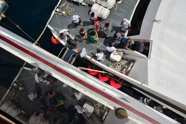 Passengers scramble aboard the ferry.