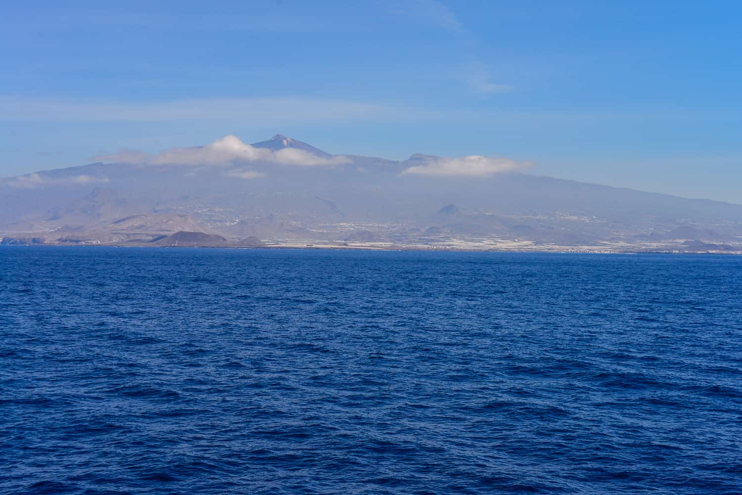 The island of Tenerife rises from the ocean.