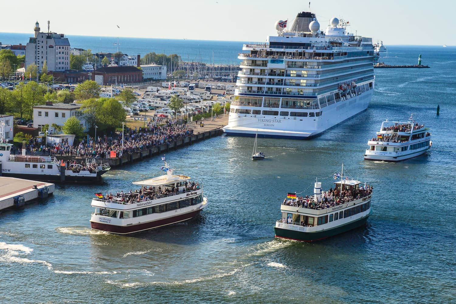 As we sail out into the Baltic the other ships blow their horns and people wave from the river bank.