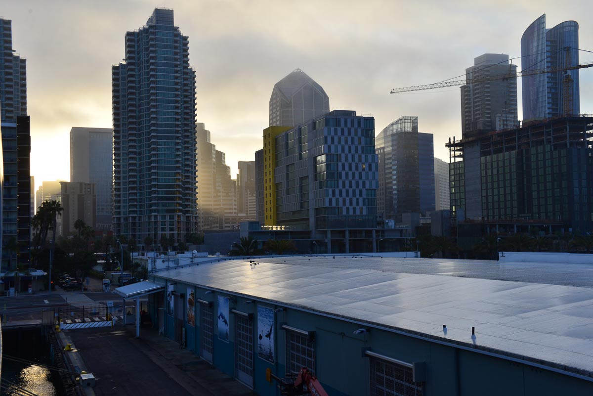 Early morning light shines through the buildings of San Diego, California