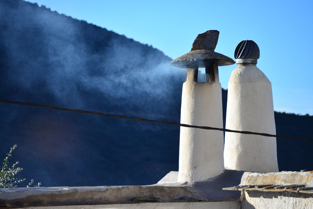 Smoking chimney in Atalbeitar La Taha, Sierra Nevada, Spain
