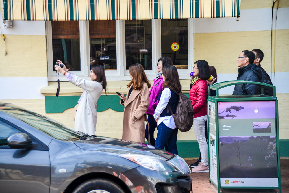 A group of people taking a selfie outside the York Motor museum