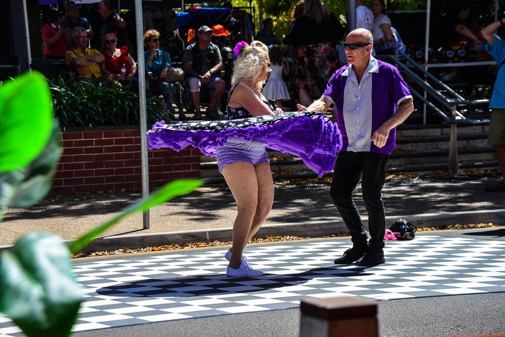 An image of dancers dressed in fifties style clothes dancing to country music in the streets of Maryborough Queensland