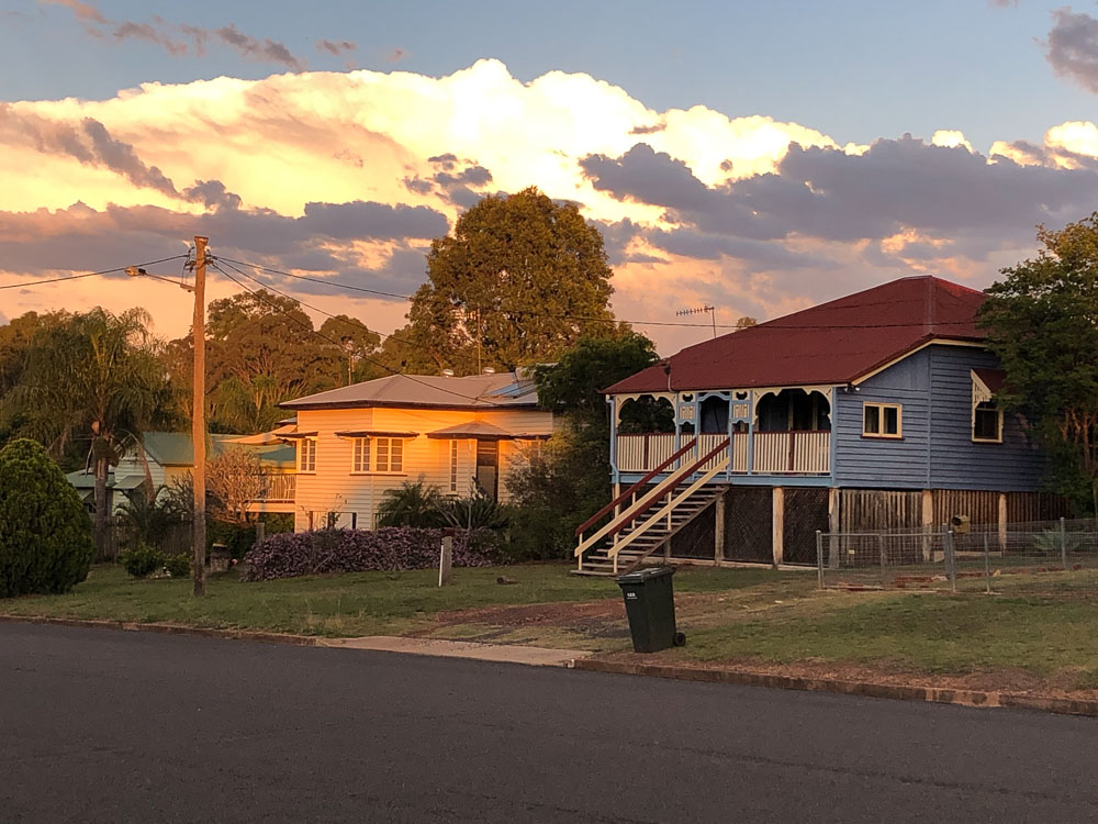Storm clounds gather over classic Queensland houses