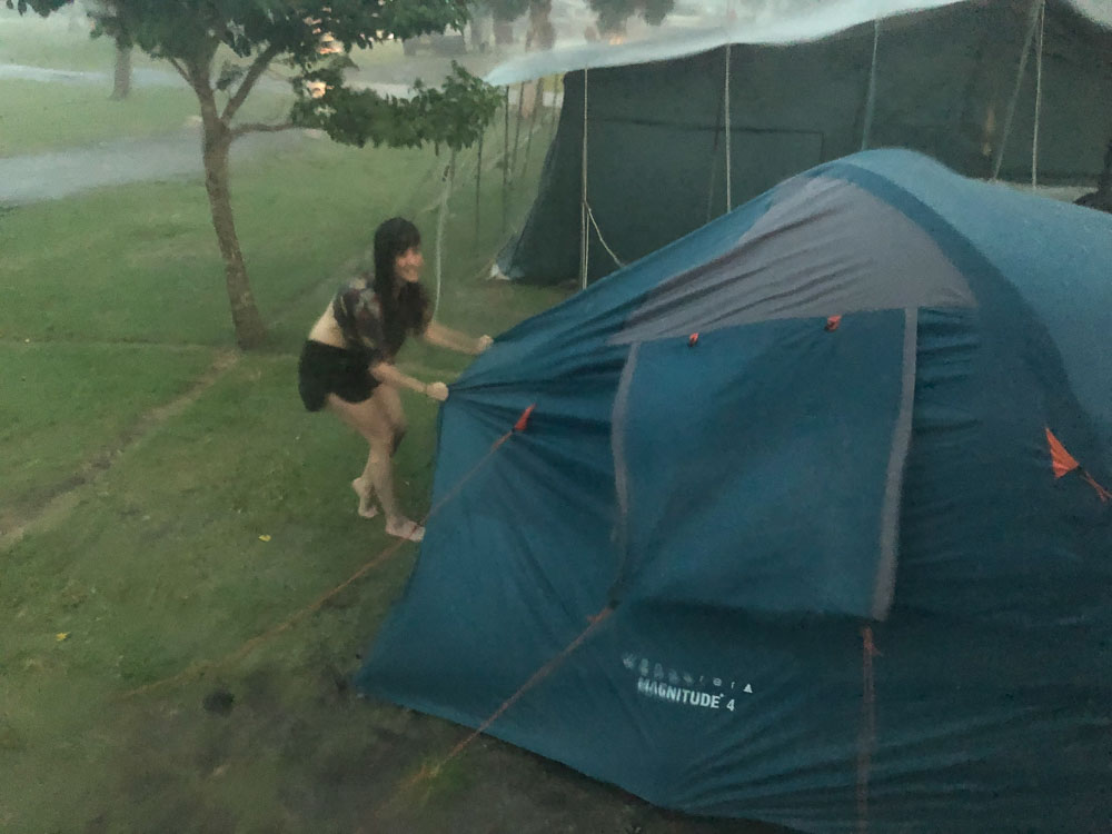 Pippa hangs onto the tent while I scrabble around to find the big pegs.